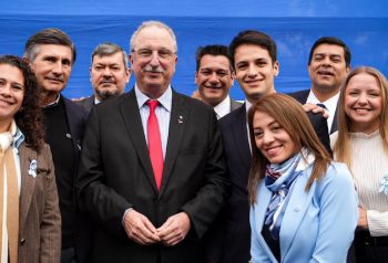 Hugo Passalacqua posa con dirigentes e intendentes frente a una bandera argentina